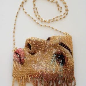 A Face Shape Purse With Brown Color Beads