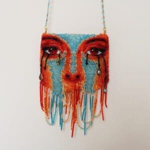 Face shaped multicolor purse on the display of the website