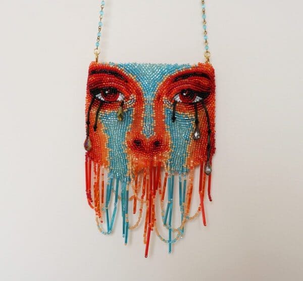 Face shaped multicolor purse on the display of the website