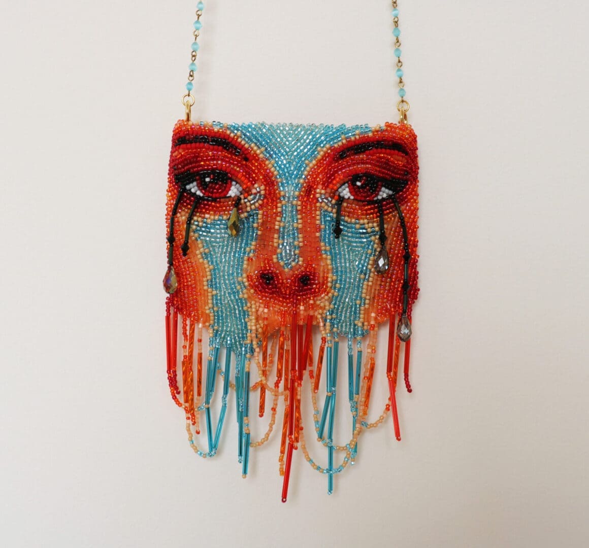 Face shaped multicolor purse on the display of the website