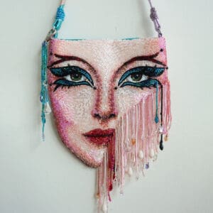 Beaded handbag with a woman's face design.