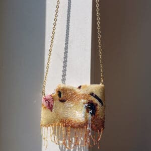 Beaded purse with a woman's face.