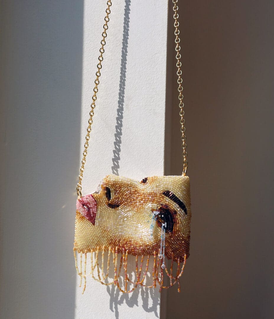 Beaded purse with a woman's face.